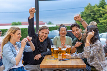 Happy friends drinking beer in a bar