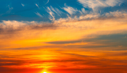 Beautiful orange clouds in the blue sunset sky