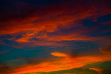 Beautiful red clouds in the dark blue sky, summer sunset