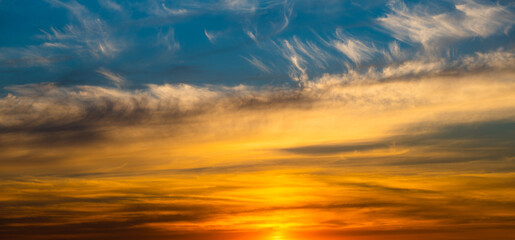 Beautiful yellow clouds in blue sunset sky