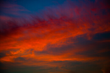 Beautiful red clouds in the dark blue sky, summer sunset