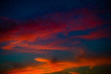 Fototapeta premium Beautiful red clouds in the dark blue sky, summer sunset