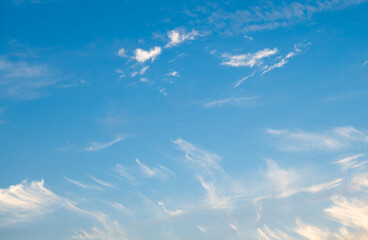 Naklejka na ściany i meble White clouds in blue sunset sky