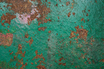 Brown stone painted with paint in pink and green. Rock background, texture. Pattern.