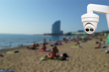 cctv camera with beach background. Blurred background with people on the beach