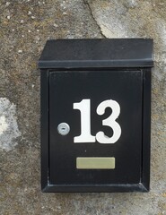 Metal letterbox with the house number 13