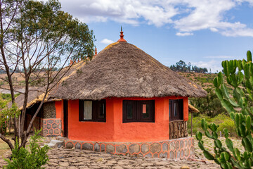 Beautiful colored traditional ethiopian house, hut situated in mountain landscape near Debre Libanos, Ethiopia, Africa. - obrazy, fototapety, plakaty