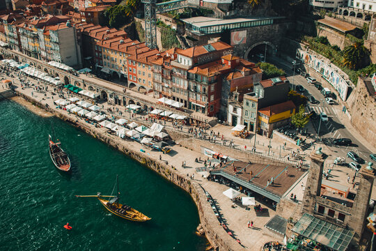 View of Oporto Downtown 'Ribeira do Porto' from the bridge D. Luis over the Douro River with Rebelo boats on it. Ribeira car tunnel.