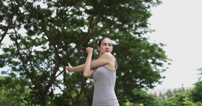 Asian young woman stretch body to warm up body. Concept for healthy lifestyle and outdoor life.