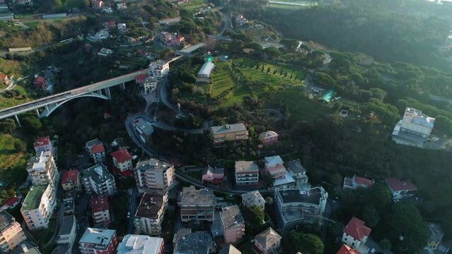 tilt shot drone shot of a community from the french cote d azur during a beautiful sunny day with a highway bridge in slow motion