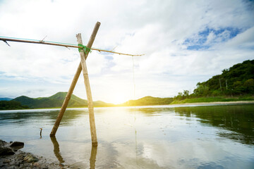 Fototapeta premium fishing in the lake in the evening behind him