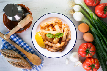 Traditional spanish tapa. Rabas, tasty fried squid with lemon.