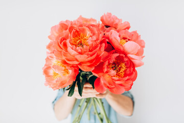 Woman with bouquet of beautiful peonies on white background, close up. Flowers to gift. Spring time and inspiration