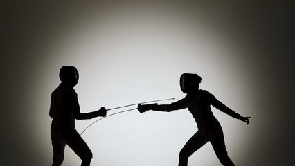 Side view of black silhouettes two young female swordswoman with crossed rapiers. Athletes in white...