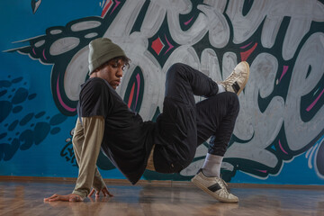 Modern rapper dancing in garage. Urban lifestyle, hip hop.