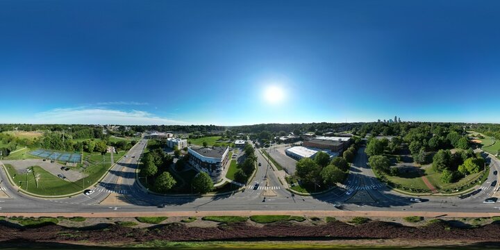 Aerial 360-degree shot of streets and traffic in Winston-Salem NC on a summer day