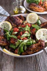 Low carb dinner with a fresh oven baked whole and carved chicken and a delicious salad with roasted vegetables and feta cheese