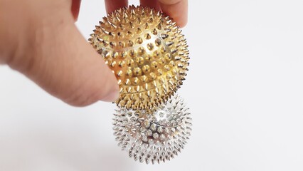 Handheld magnetic thorn ball health therapy device isolated on white background