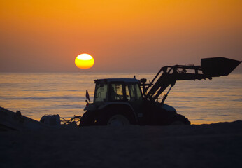 A tractor at sunset, symbolizing energy and the sun