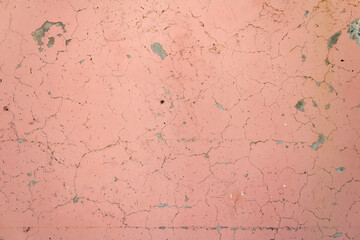 Fototapeta premium texture of cracked scratched cement wall with old pink paint
