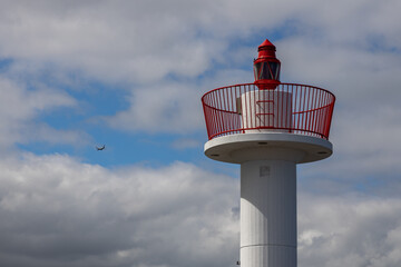 Crown, head of the lighthouse at the entrance to Howth Harbor in daylight with a beautiful blue...