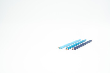 blue wooden colored pencil on a white background with end part in focus