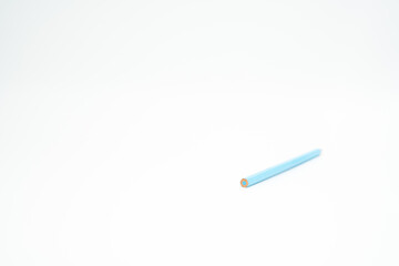 blue wooden colored pencil on a white background with end part in focus
