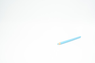 blue wooden colored pencil on a white background with a point (lead) in focus