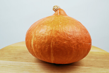 one orange pumpkin on wooden background