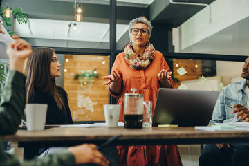 Mature businesswoman leading a meeting in a creative office