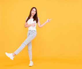 Fototapeta na wymiar Full length of Happy young woman standing and pointing