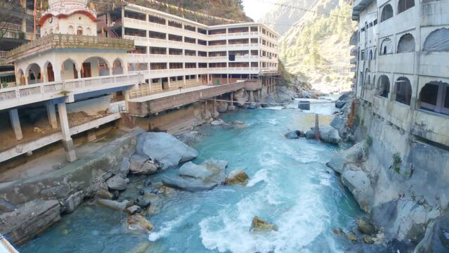 4K Wide angle shot of Gurudwara Sahib Manikaran with river Parvati flowing besides the Gurudwara at Manikaran near Kasol in Himachal Pradesh, India. River flowing besides the Gurudwara. 