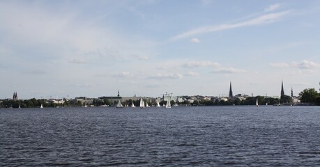 Fototapeta premium Sightseeing tour on the Alster in Hamburg with a view of 5 famous church towers