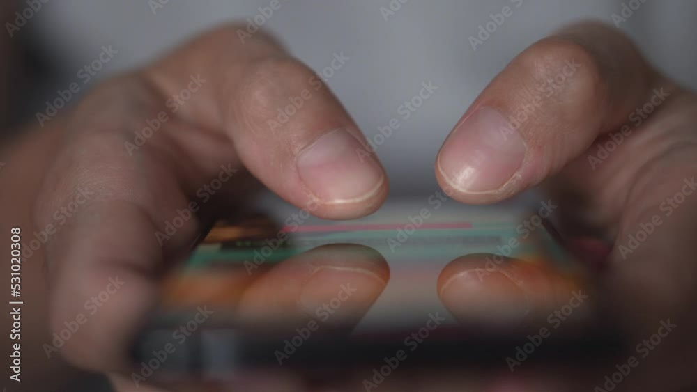 Poster life in a smartphone. a young man looks at a mobile phone and browses social networks, close-up. rel