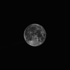 Airplane on the background of the full moon