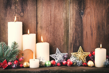 Christmas Advent candles with festive decor.
