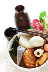 Homemade Japanese winer comfort food, oden fish cake and radish simmered, served with Japanese wine Hot saki