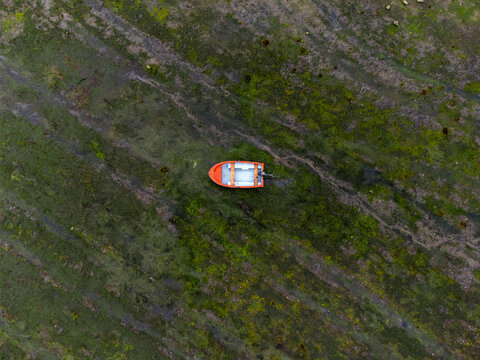 Drone view of one fishermans's boat stranded on the sand