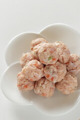 Homemade Chinese chicken and carrot meat ball on white dish for cooking ingredient