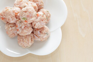 Homemade Chinese chicken and carrot meat ball on white dish for cooking ingredient