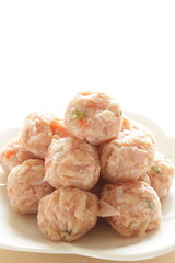 Homemade Chinese chicken and carrot meat ball on white dish for cooking ingredient