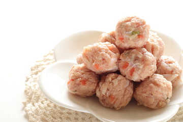 Homemade Chinese chicken and carrot meat ball on white dish for cooking ingredient