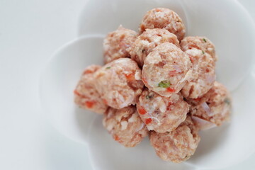 Homemade Chinese chicken and carrot meat ball on white dish for cooking ingredient