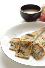 Korean food, leek pan cake with chili sauce and wine Makgeolli 