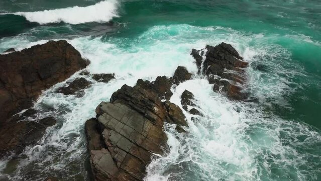 Foamy Waves Crashing Onto Outcrops At The Seacoast In Sinemorets, Bulgaria. Aerial Shot