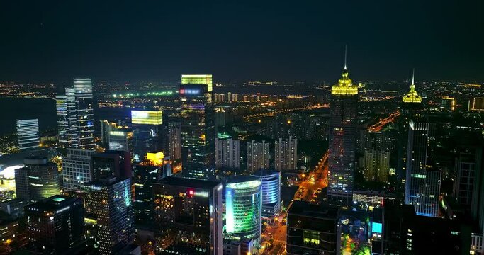 Aerial footage of city skyline and modern commercial buildings scenery in Suzhou at night, China. Famous CBD building complex in Suzhou.