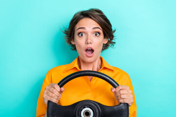 Photo of young attractive pretty nice cute woman hold steering wheel wear orange shirt shocked car crash isolated on cyan color background