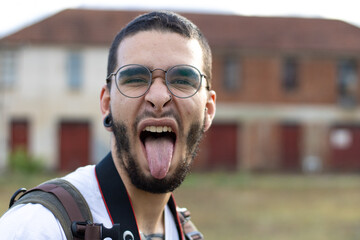 young man sticking out tongue