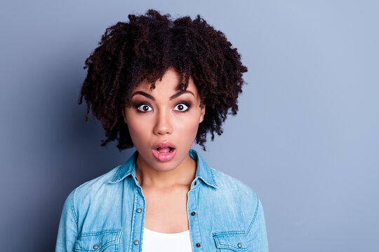 Close up photo of pretty frightened lady curly hairstyle open mouth impressed discounts wear denim shirt isolated on gray color background