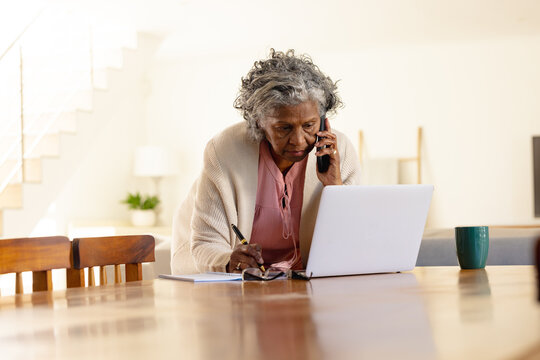 Senior african american women using laptop and phone